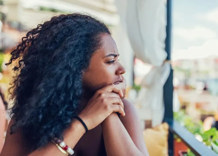 Unhappy woman on a vacation staring into the distance